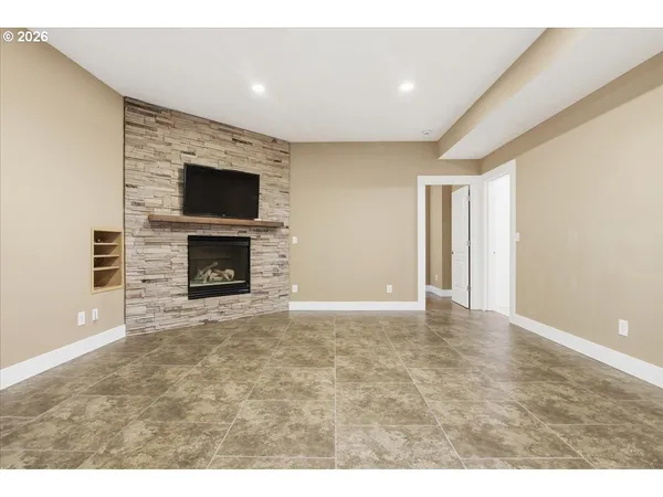 a view of empty room with a fireplace