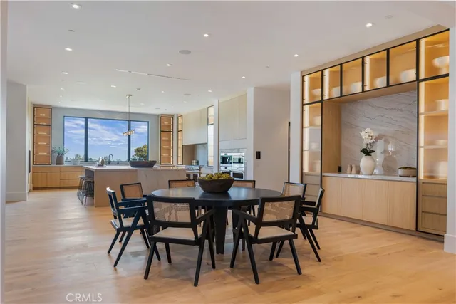 a dining room with a wooden table and chairs