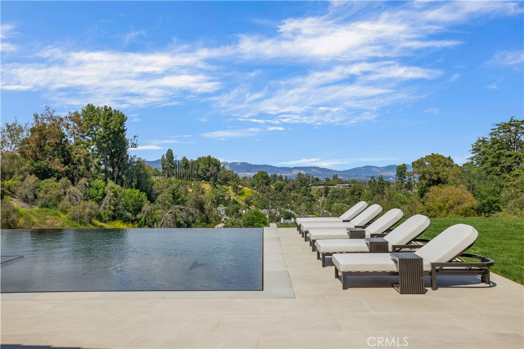 24105 Hidden Ridge Road Hidden Hills, CA 91302 - Photo 43 of 52 an outdoor sitting area with a lake view