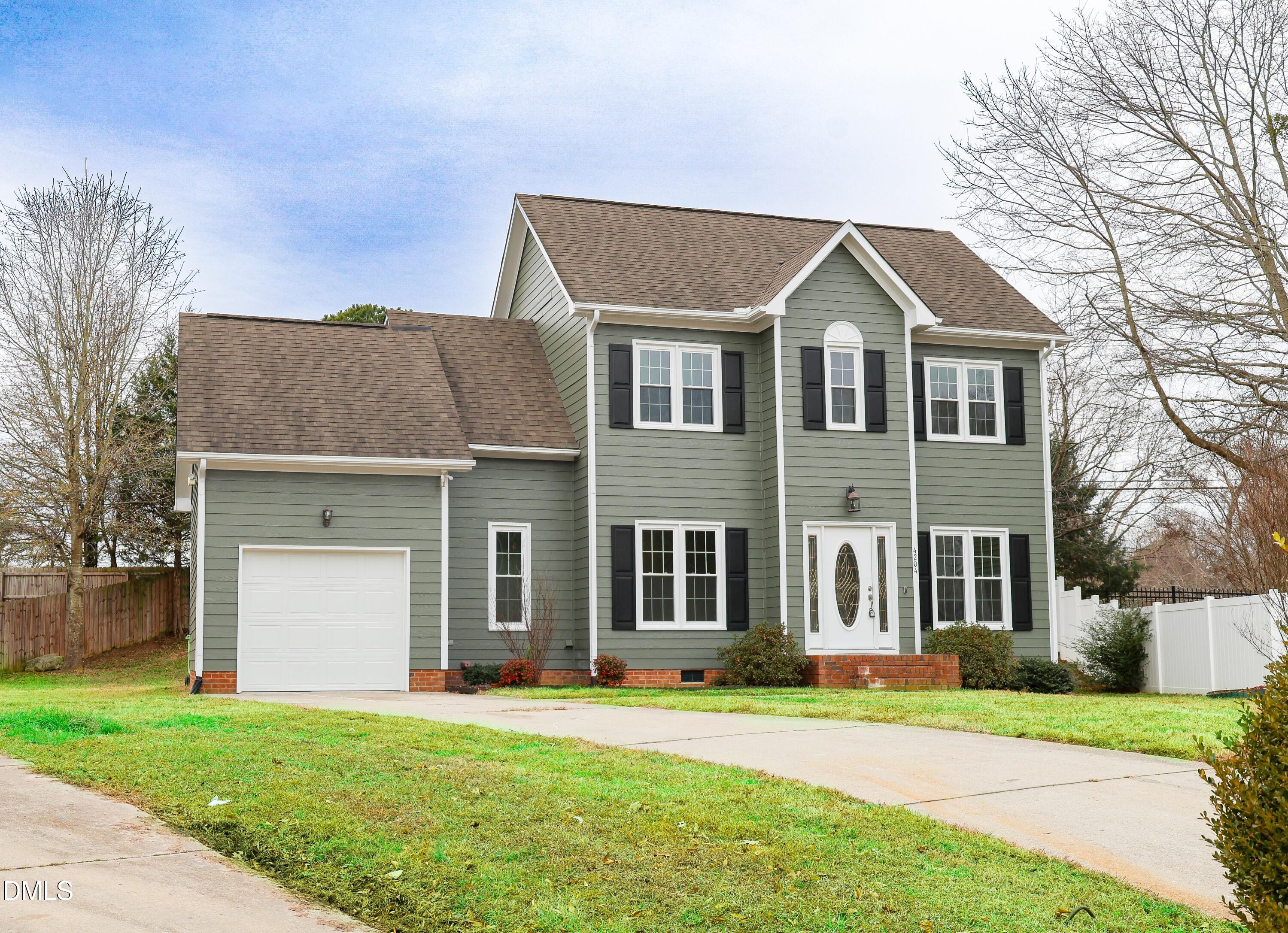 4204 Belington Court Raleigh, NC 27604 - Photo 1 of 18 a front view of a house with a yard and garage