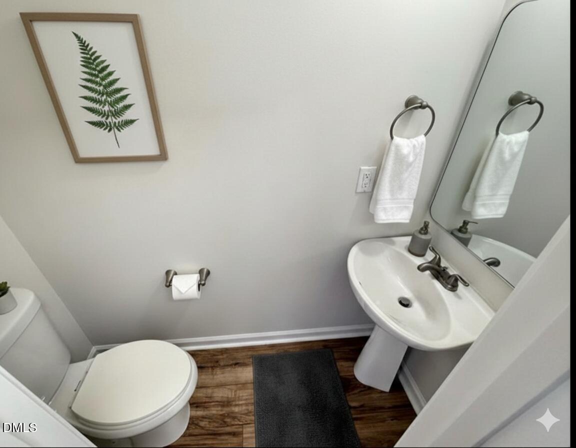 4204 Belington Court Raleigh, NC 27604 - Photo 11 of 26 a bathroom with a toilet sink and mirror