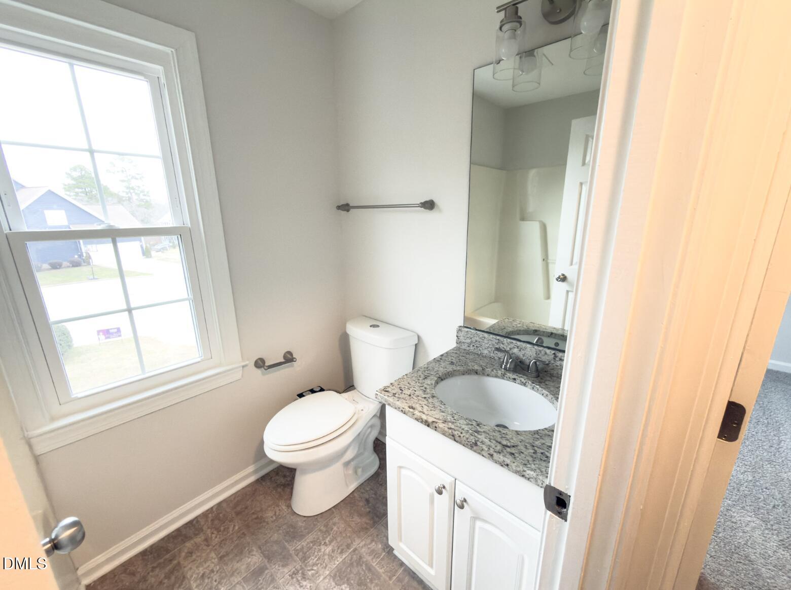4204 Belington Court Raleigh, NC 27604 - Photo 20 of 26 a bathroom with a sink and a toilet