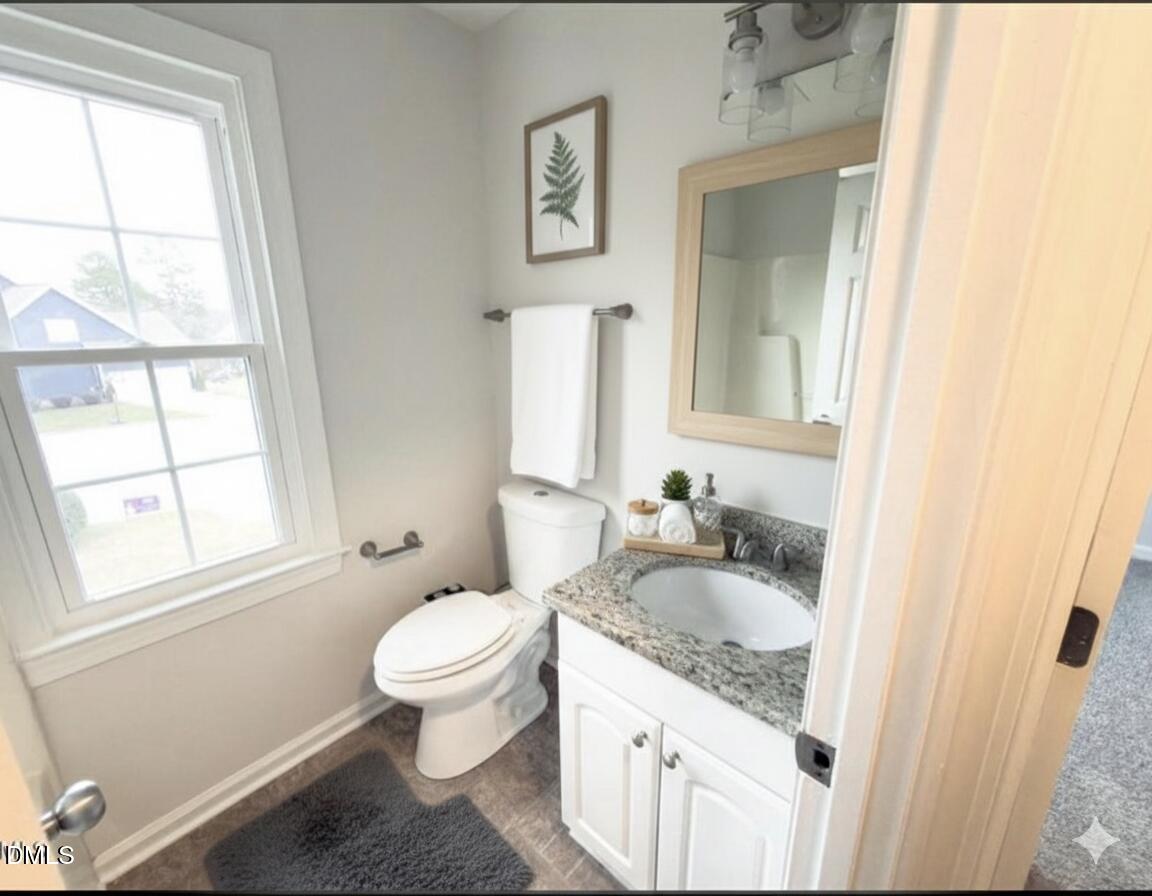 4204 Belington Court Raleigh, NC 27604 - Photo 21 of 26 a white toilet sitting next to a bathroom sink