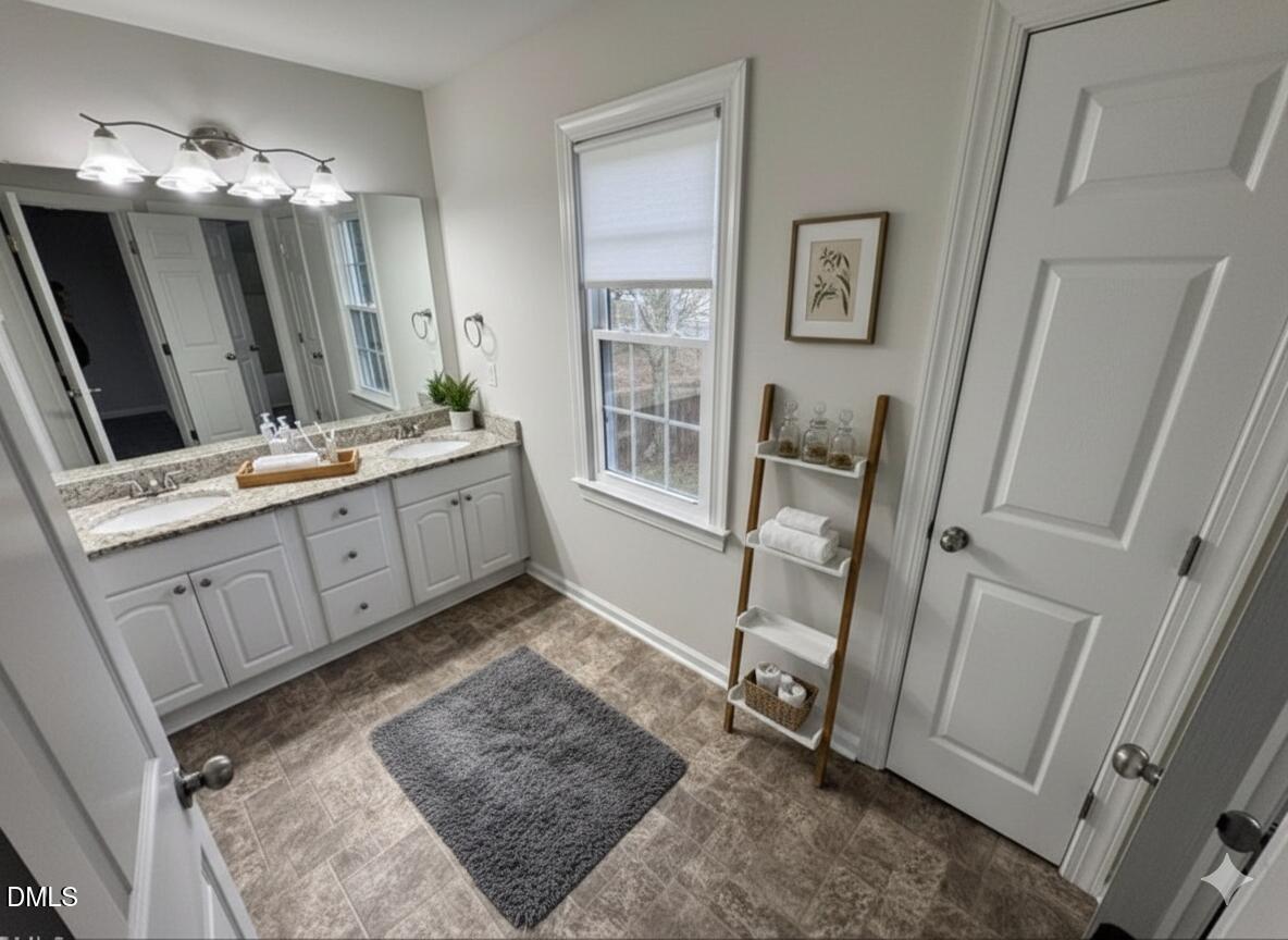 4204 Belington Court Raleigh, NC 27604 - Photo 23 of 26 a bathroom with a double vanity sink and a mirror