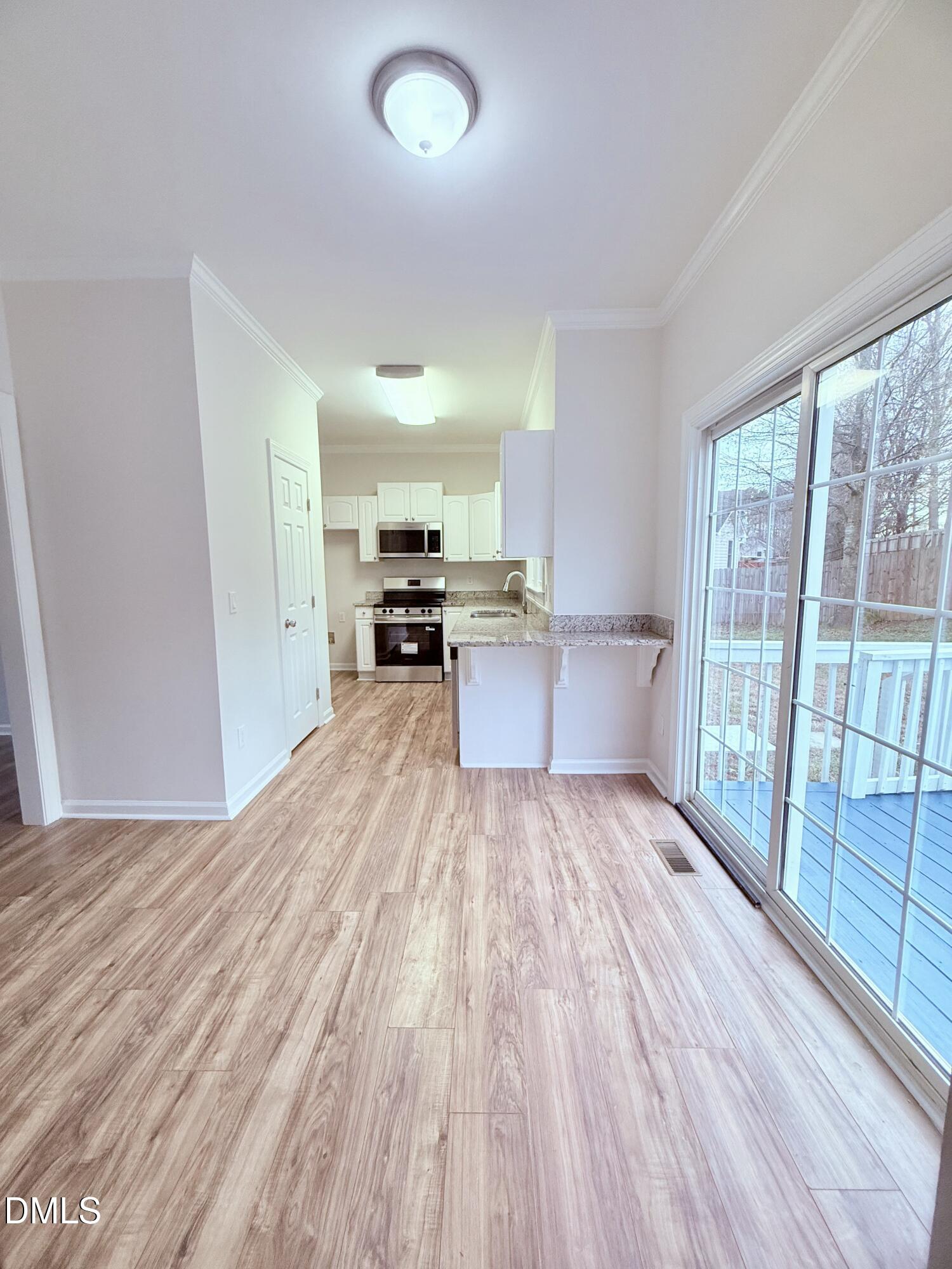 4204 Belington Court Raleigh, NC 27604 - Photo 5 of 18 a view of a kitchen with wooden floor and electronic appliances