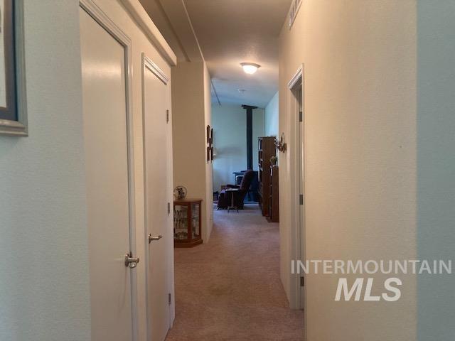 1095 County Road 70 Weiser, ID 83672 - Photo 19 of 44 Hallway with carpet flooring, white walls, and white trim