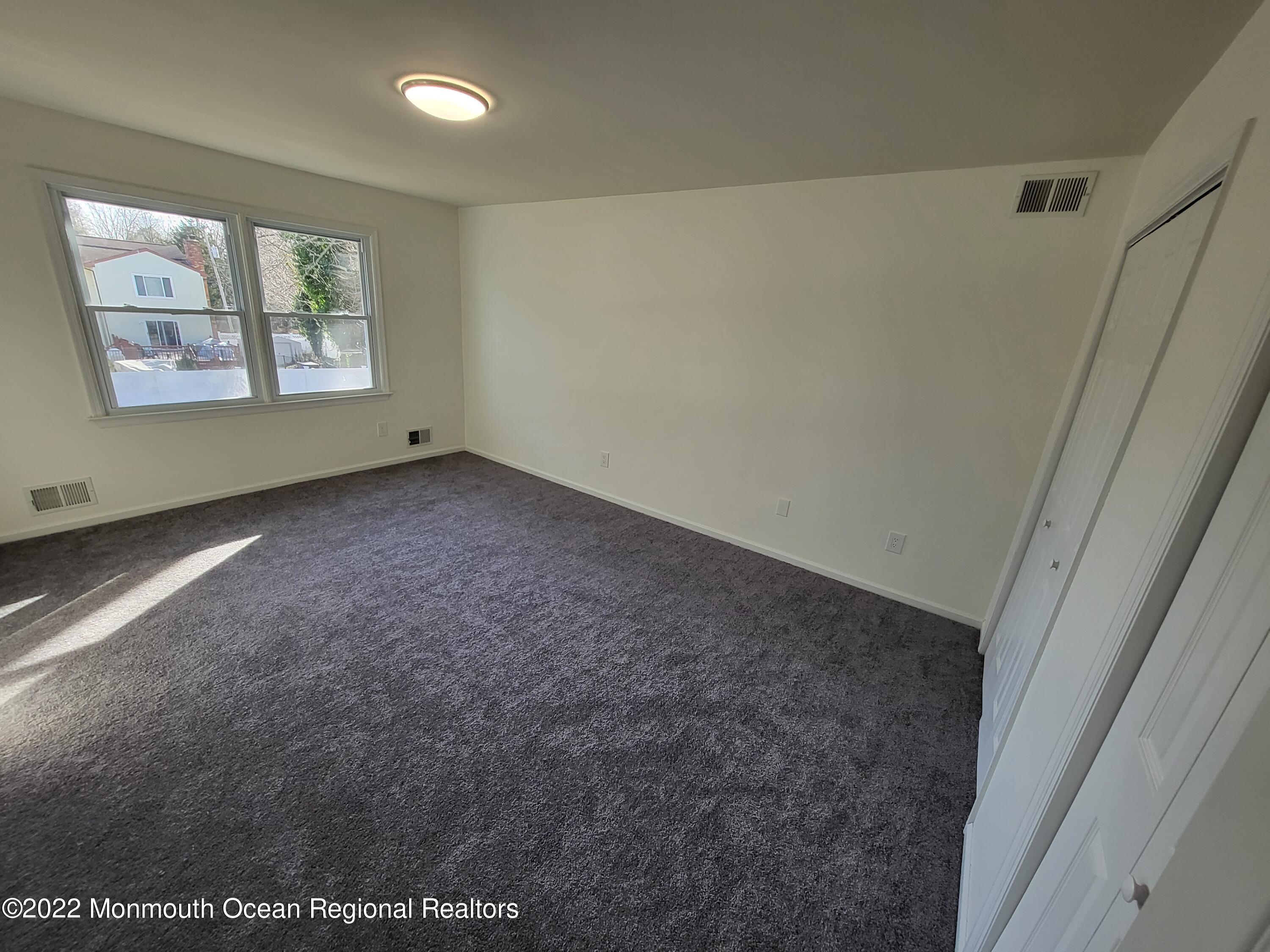 13 Spicy Pond Road Howell, NJ 07731 - Photo 7 of 7 an empty room with windows & cabinet area