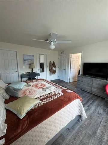 a bed sitting in a spacious bedroom and a larger closet