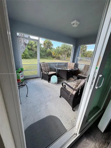 a living room with furniture and a floor to ceiling window