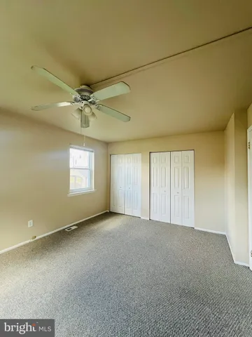 an empty room with a empty space and windows