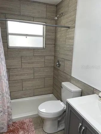 a bathroom with a toilet a sink and bathtub