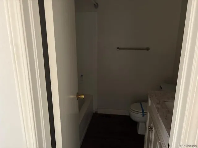 a bathroom with a toilet and a window