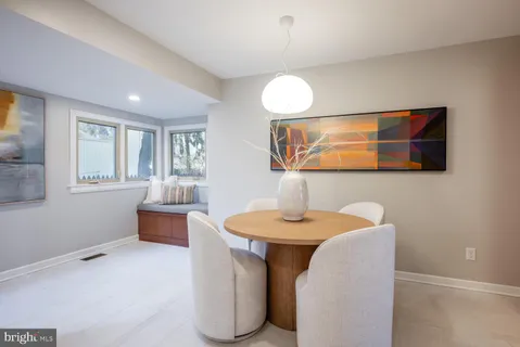 a kitchen with a table and chairs in it