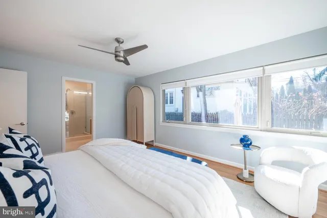 a living room with a bed furniture and a large window