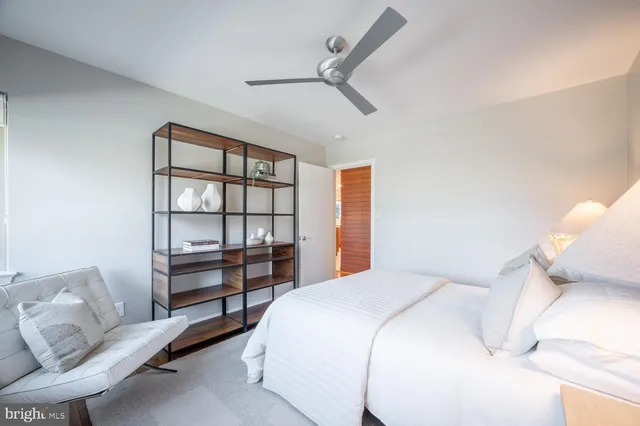 a bathroom with a sink and mirror with toilet
