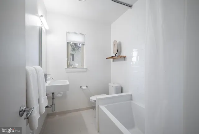 a spacious bedroom with a bed and a large window