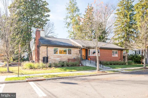 a front view of a house with a yard and fountain