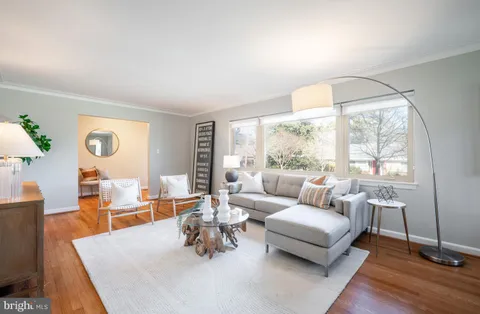 a large kitchen with stainless steel appliances wooden cabinets and a sink