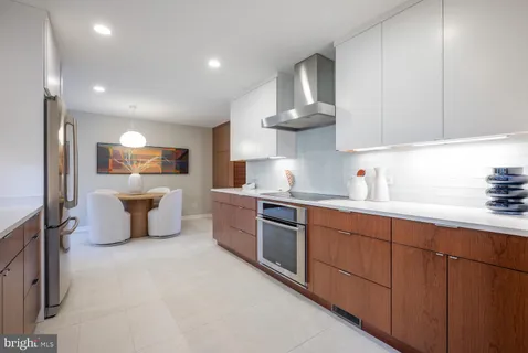 a kitchen with stainless steel appliances a refrigerator and a stove top oven