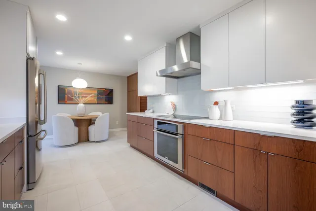 a kitchen with stainless steel appliances a refrigerator and a stove top oven