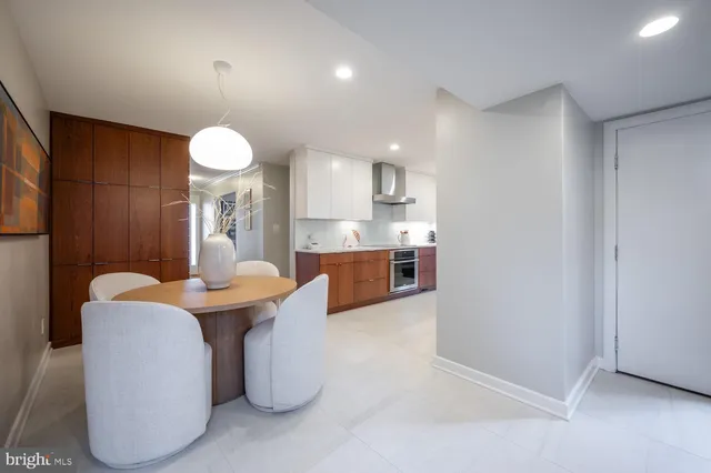 a dining room with furniture and a chandelier