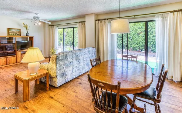 a dining room with furniture and wooden floor