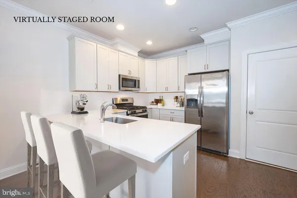 a view of a kitchen with a sink cabinets and wooden floor