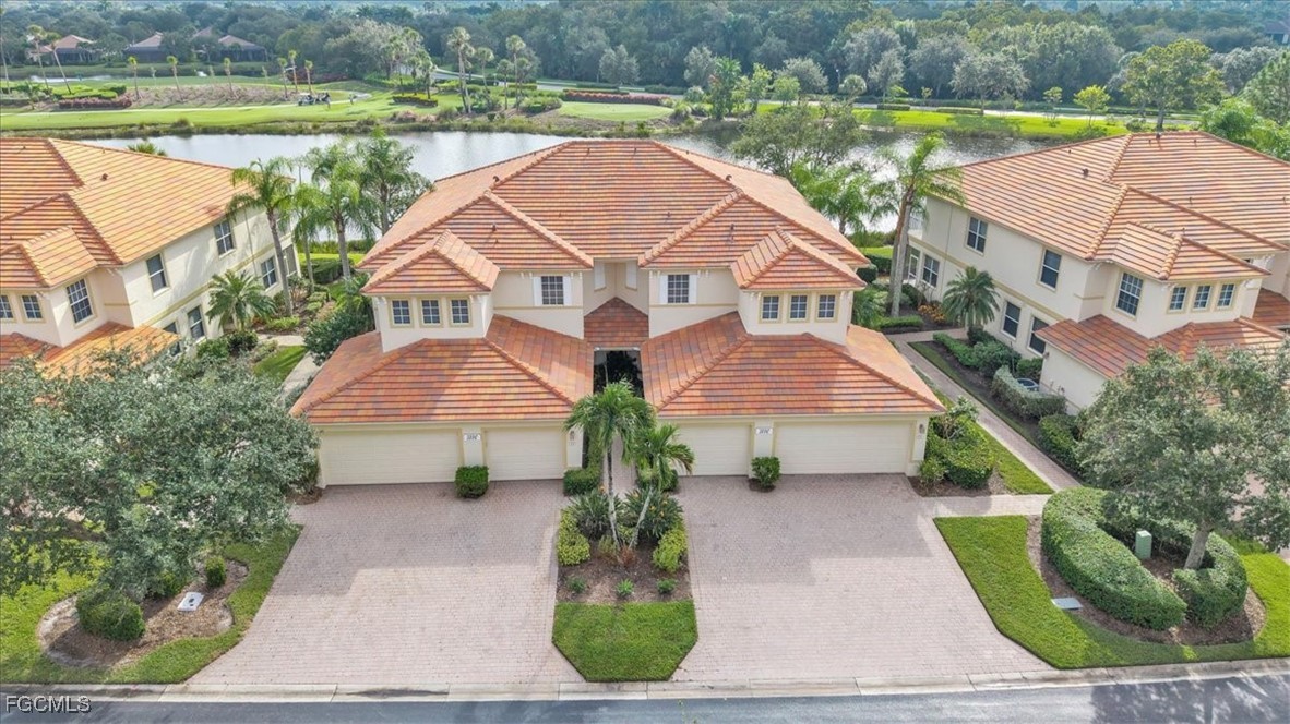 an aerial view of a house with a yard and a sitting area