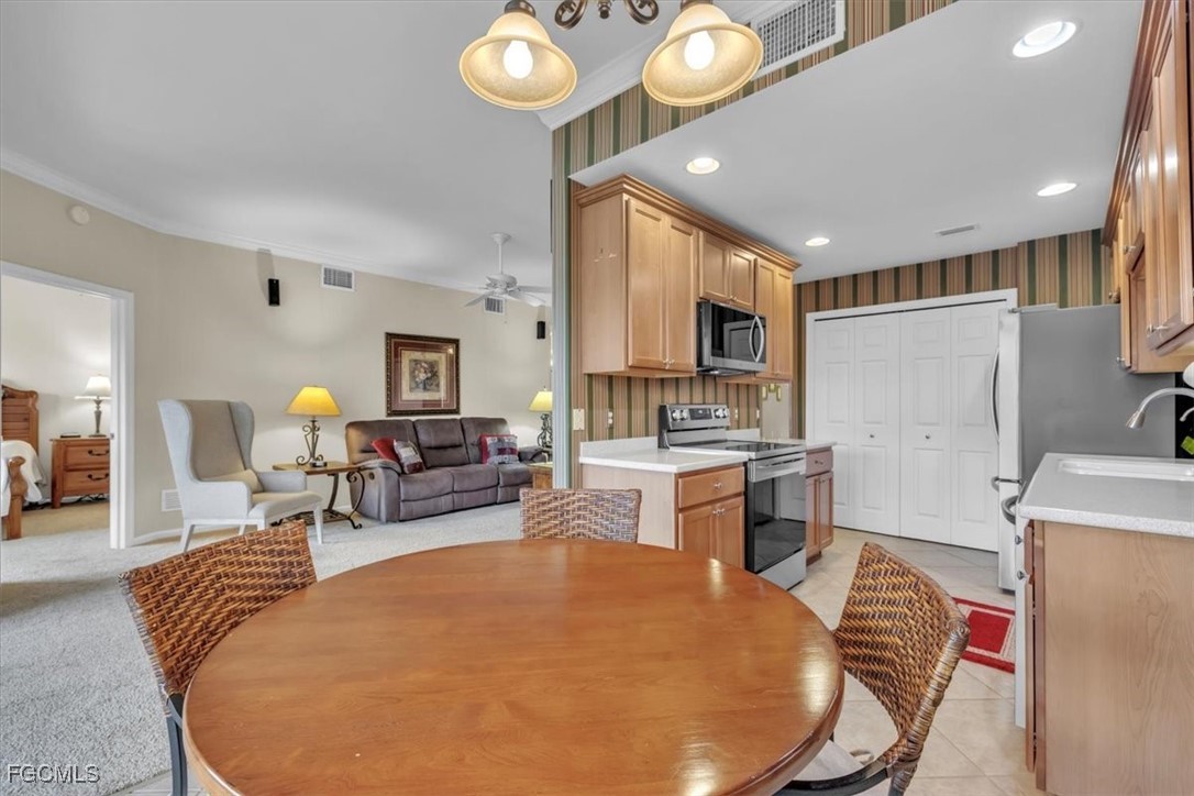 3110 Meandering Way, Unit 101 Fort Myers, FL 33905 - Photo 13 of 50 a living room with stainless steel appliances furniture and a view of kitchen