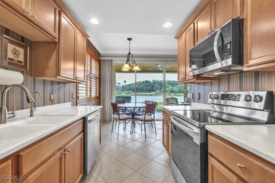3110 Meandering Way, Unit 101 Fort Myers, FL 33905 - Photo 16 of 50 a kitchen with stainless steel appliances granite countertop a sink and a stove