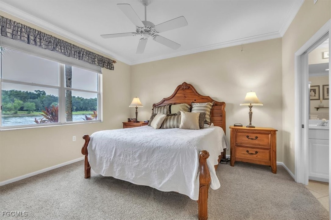 3110 Meandering Way, Unit 101 Fort Myers, FL 33905 - Photo 21 of 50 a bedroom with a bed and a chandelier