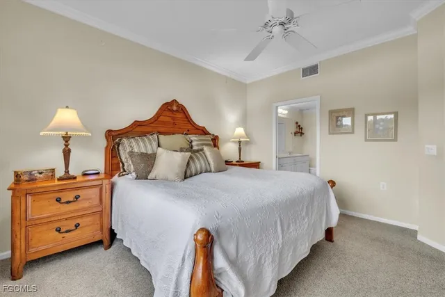 a bedroom with a bed and a lamp on dresser