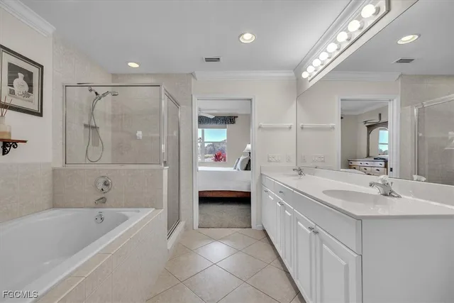 a spacious bathroom with a tub sink shower and mirror