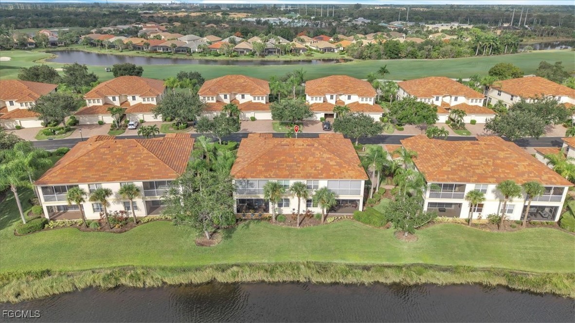 3110 Meandering Way, Unit 101 Fort Myers, FL 33905 - Photo 48 of 50 an aerial view of residential houses with outdoor space and lake view