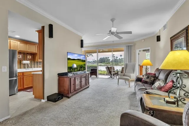 a living room with furniture a window and flat screen tv