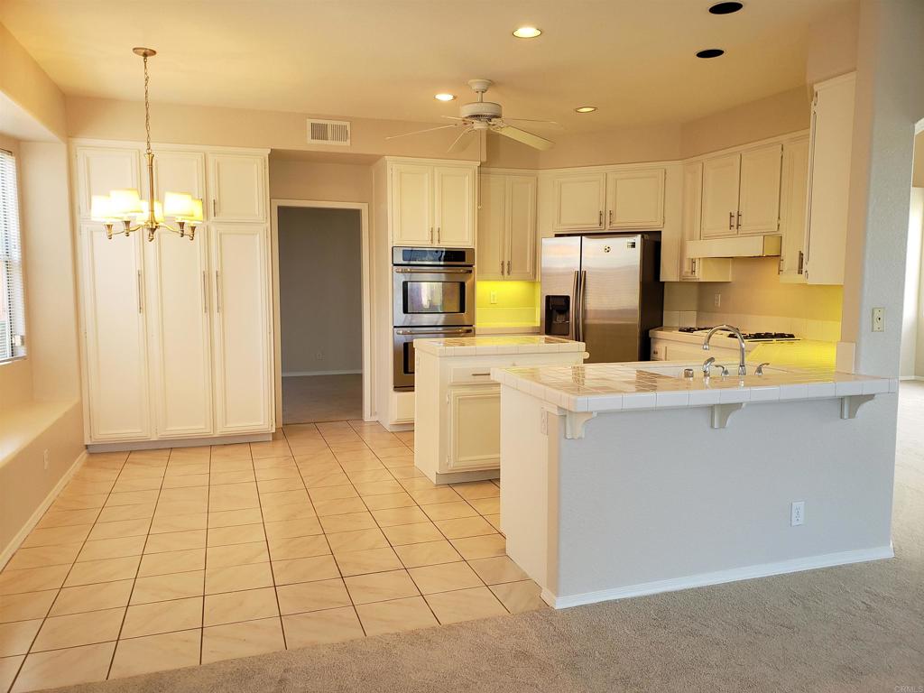 5132 Via Seville Oceanside, CA 92056 - Photo 2 of 7 a kitchen with stainless steel appliances a refrigerator sink and microwave