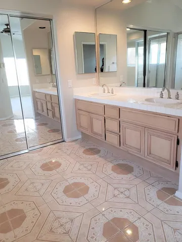 a bathroom with a sink a toilet and mirror