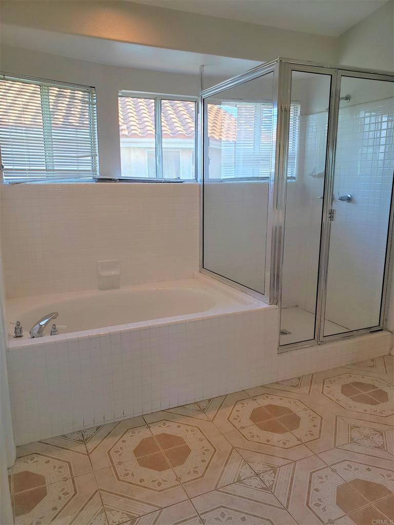 5132 Via Seville Oceanside, CA 92056 - Photo 6 of 7 a bathroom with a bathtub and a shower