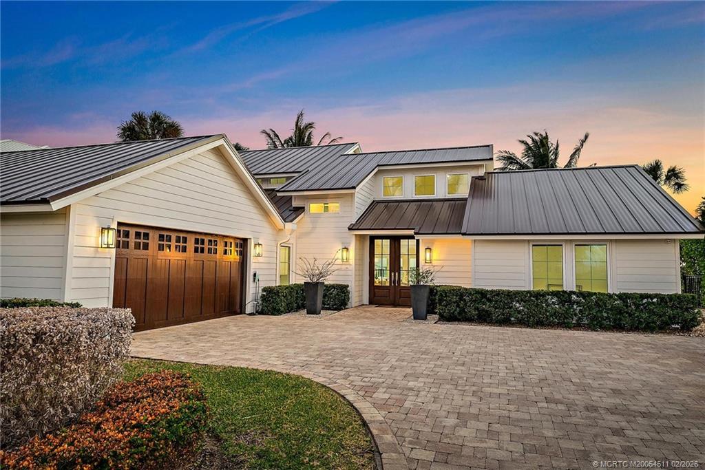 4230 Northeast Joes Point Road Jensen Beach, FL 34957 - Photo 3 of 62 a front view of a house with garden