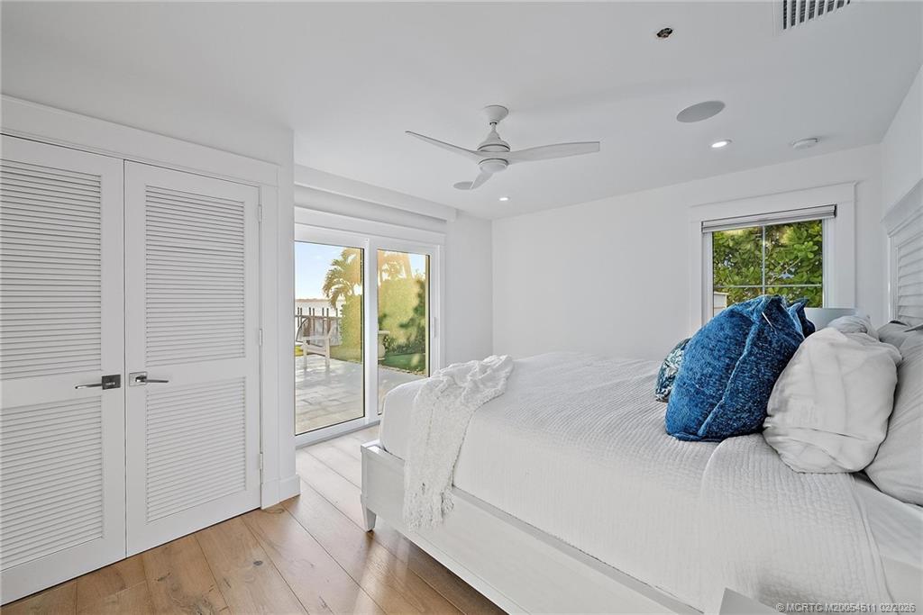 4230 Northeast Joes Point Road Jensen Beach, FL 34957 - Photo 34 of 62 a bed room with a bed and a window