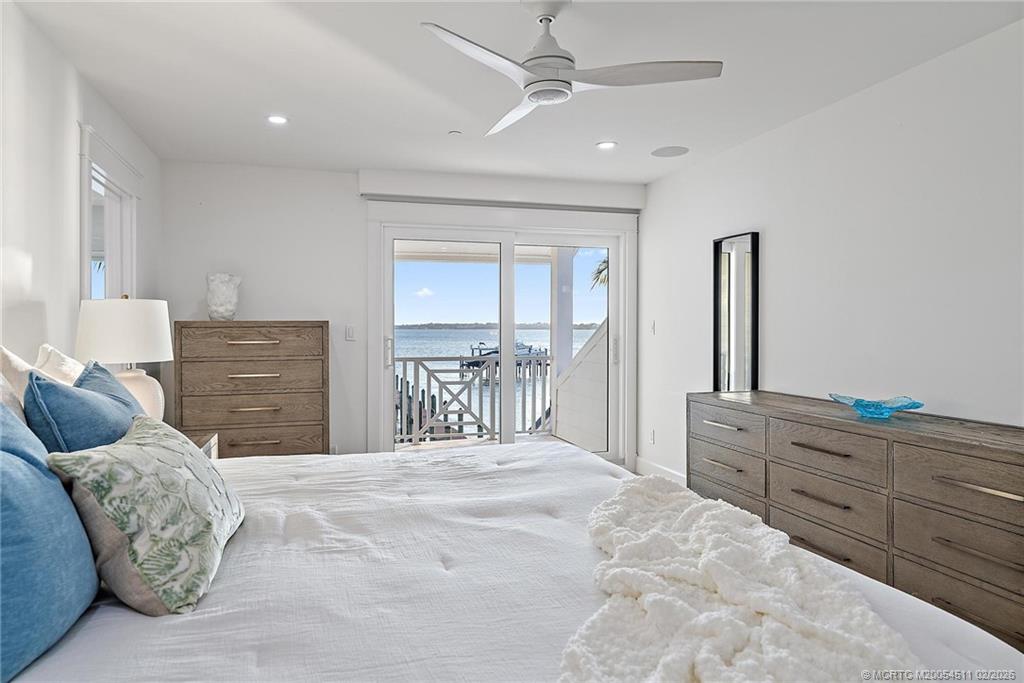 4230 Northeast Joes Point Road Jensen Beach, FL 34957 - Photo 36 of 62 a bedroom with a large bed and a dresser