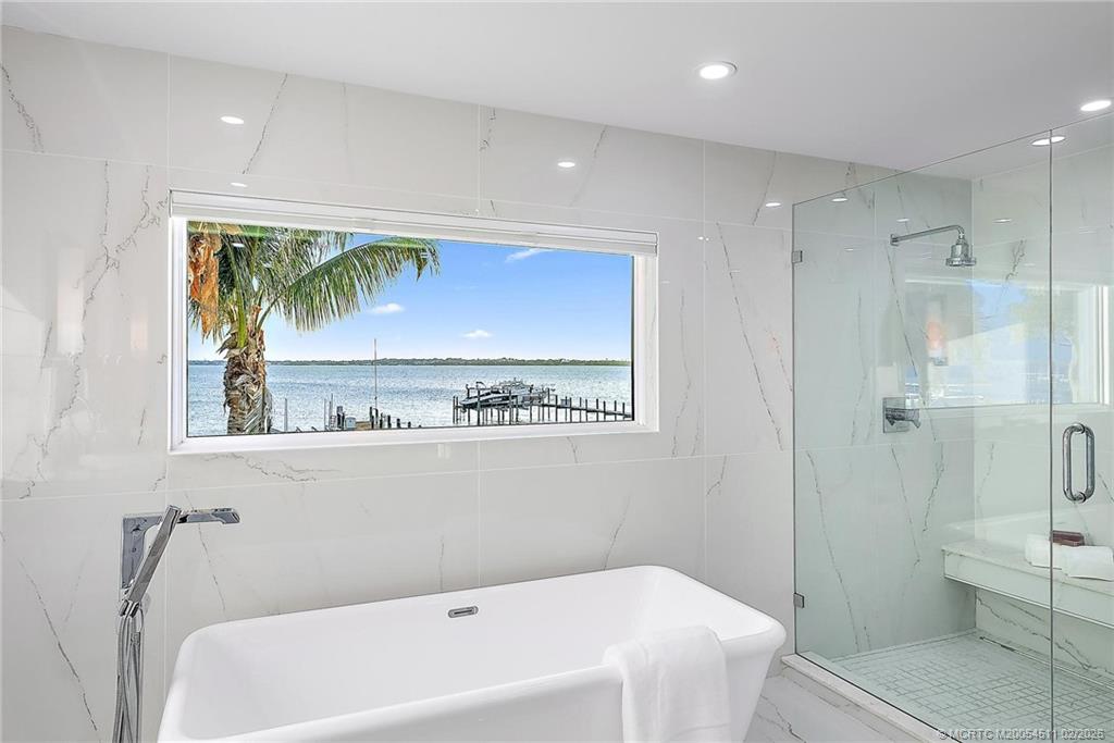 4230 Northeast Joes Point Road Jensen Beach, FL 34957 - Photo 41 of 62 a bathroom with a bathtub and a shower