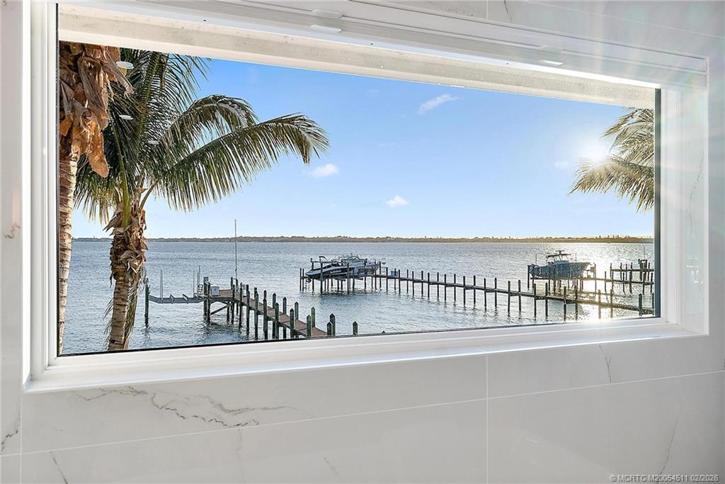 4230 Northeast Joes Point Road Jensen Beach, FL 34957 - Photo 42 of 62 a view of a swimming pool with a table and chairs