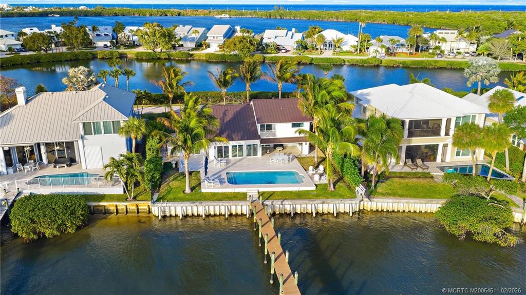 4230 Northeast Joes Point Road Jensen Beach, FL 34957 - Photo 47 of 62 an aerial view of residential houses with outdoor space and lake view