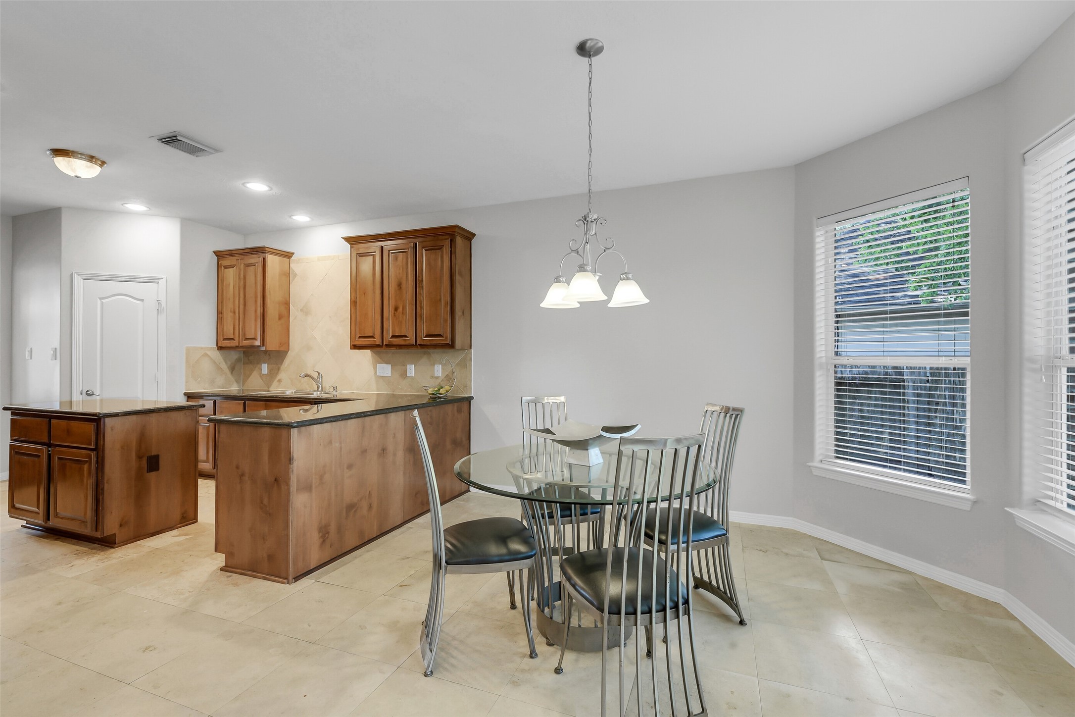 14906 Windsor Manor Houston, TX 77069 - Photo 10 of 34 Light and bright breakfast space with extensive tile flooring ~