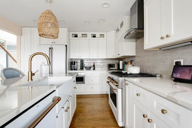 a kitchen with stainless steel appliances granite countertop a sink and cabinets