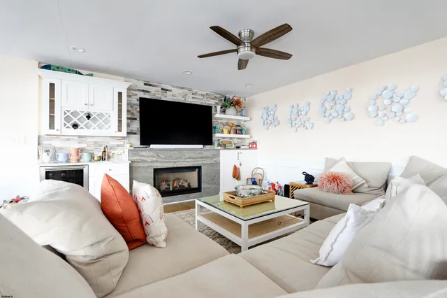 a living room with furniture a fireplace and a flat screen tv