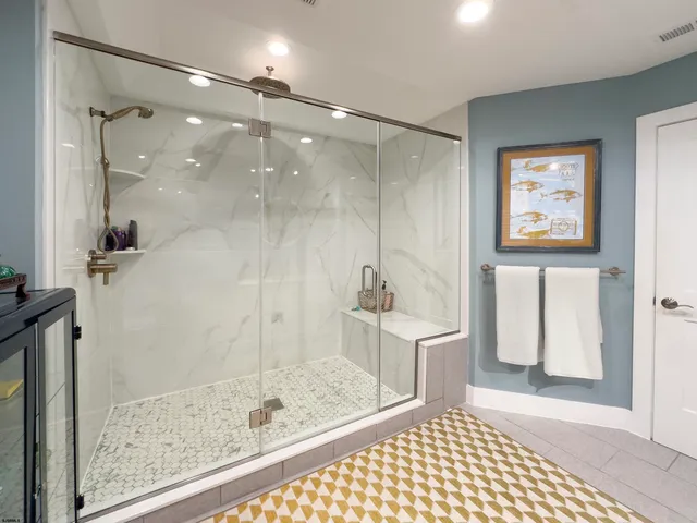 a bathroom with a glass shower door