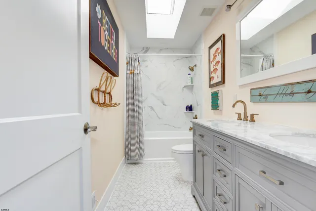 a spacious bathroom with a granite countertop sink mirror vanity and a shower