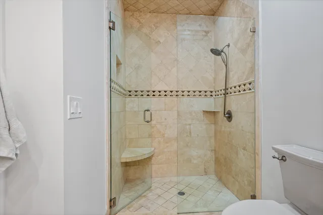 a bathroom with a shower and toilet